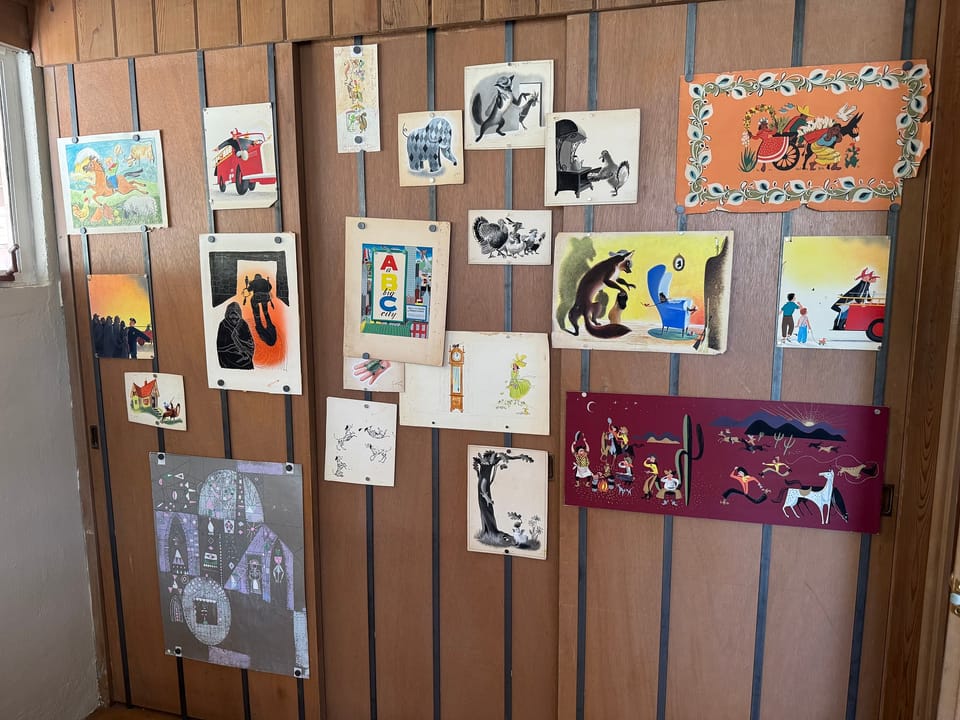 Art exhibit on the wood-paneled walls
