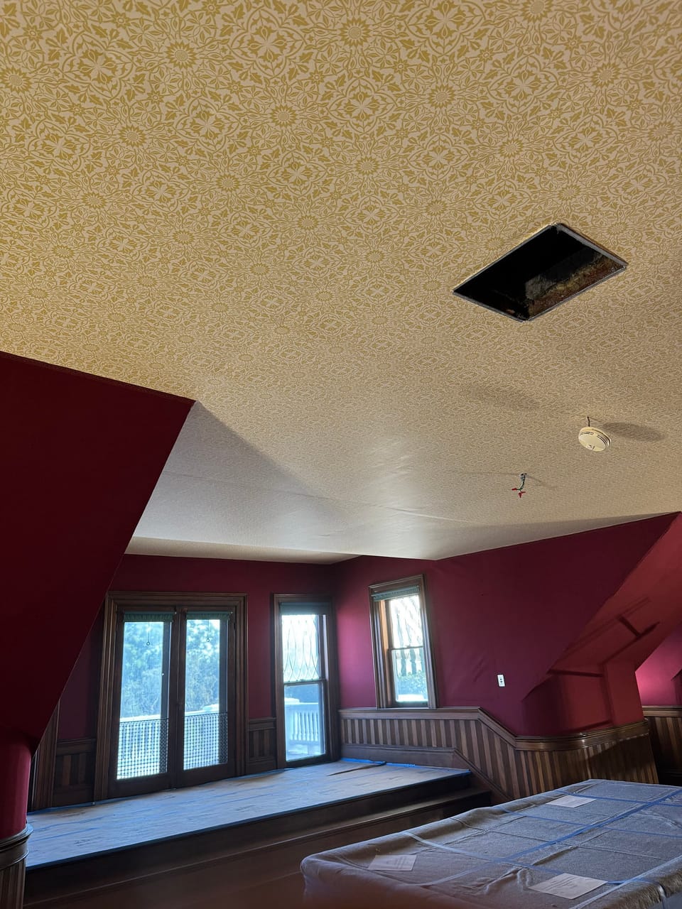 Finished ceiling meeting the red sidewalls at a dormer