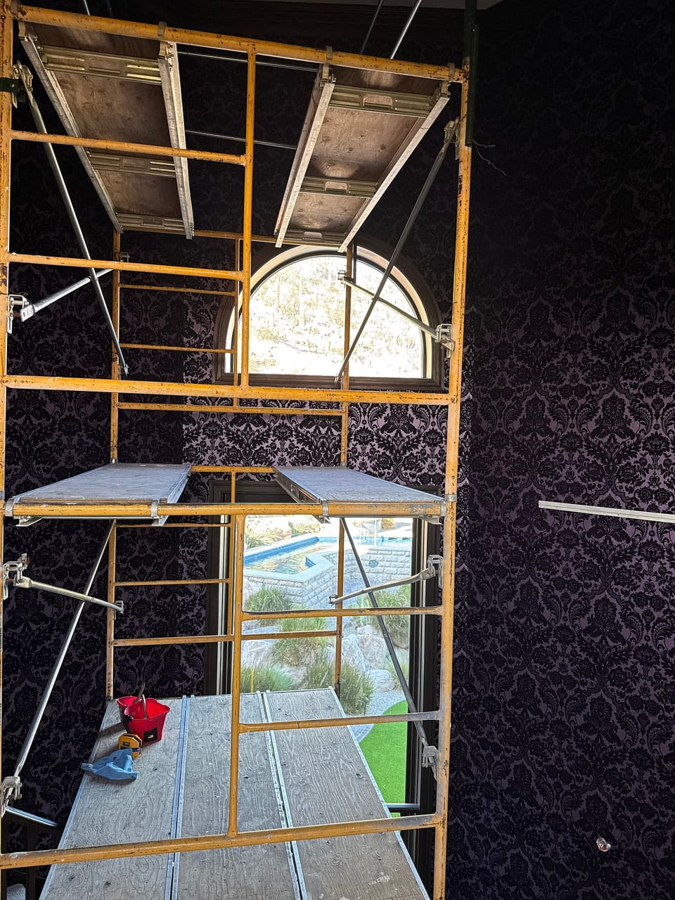 Flocked damask on the octagonal staircase, with scaffolding