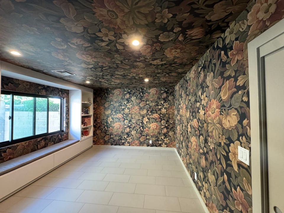Floral mural carried from the walls onto the ceiling