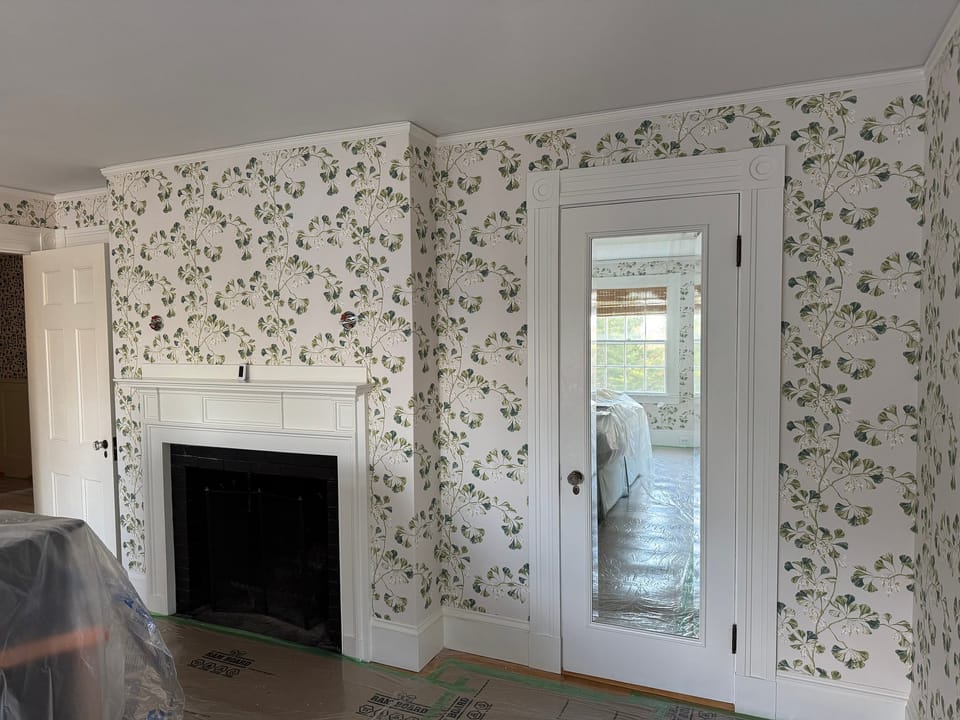 Floral print in a room with a fireplace and glass door
