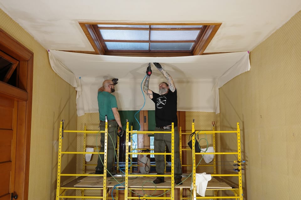 Installing the ceiling over stretched canvas from scaffolding