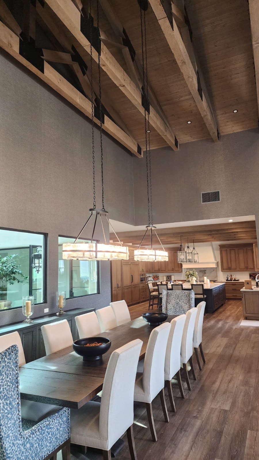 Textured wallcovering in a great room with the kitchen beyond