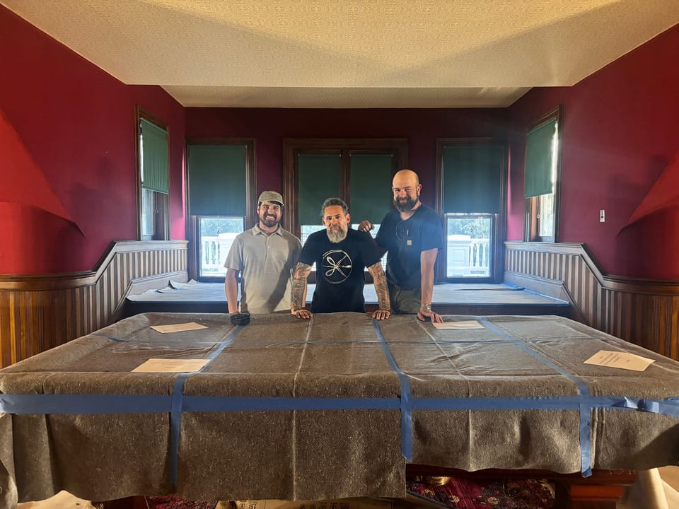 The installers with canvas laid out on the third floor