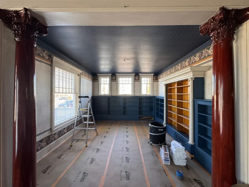 The long room with damask above the bookcases